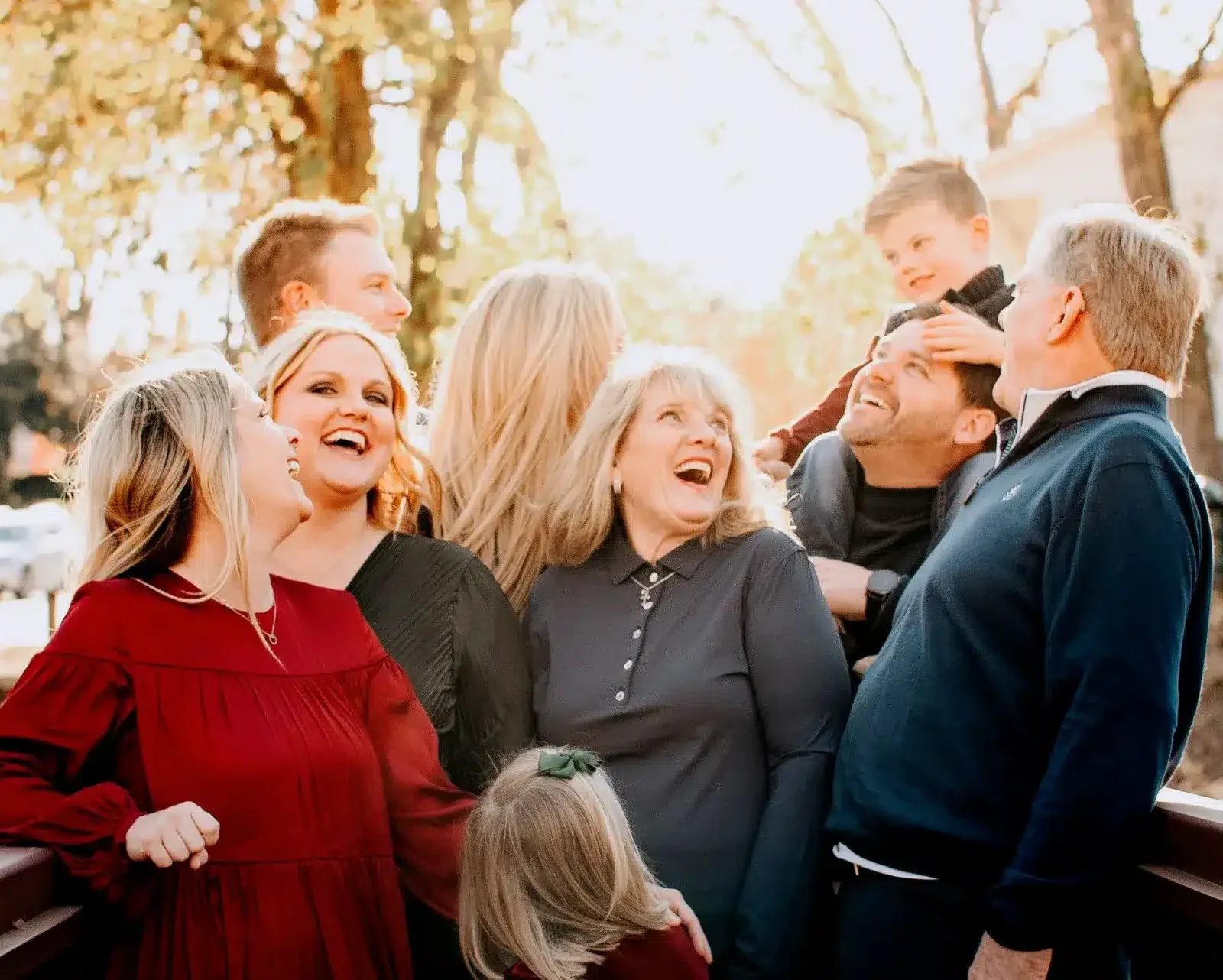 legacy-design Happy multigenerational family laughing together outdoors in fall, celebrating shared stories and family memories