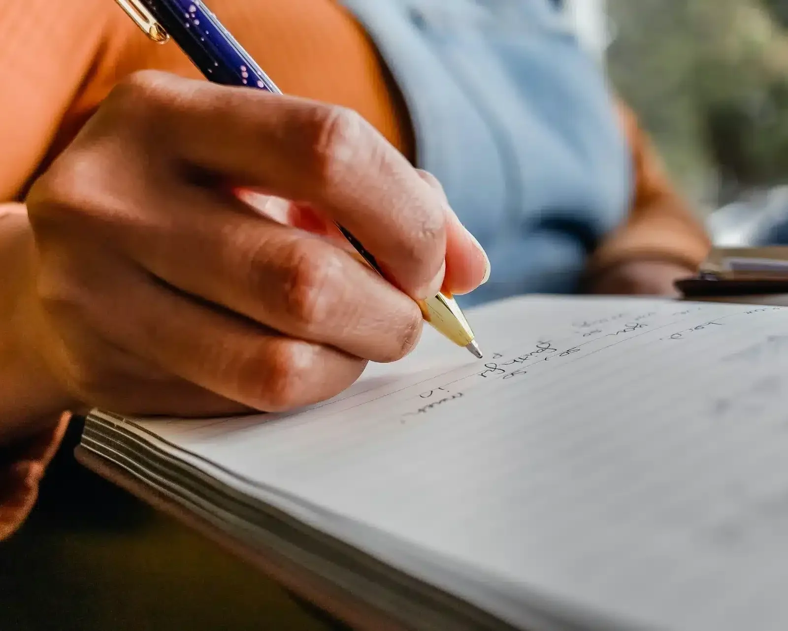 legacy-letter Person writing in a notebook to clarify personal vision, values, and life purpose