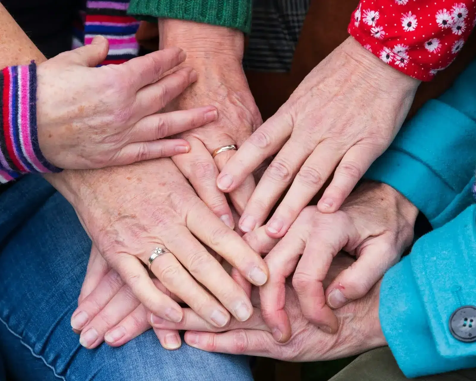 vision-vaule-purpose Multi-generational family hands stacked together symbolizing unity and support